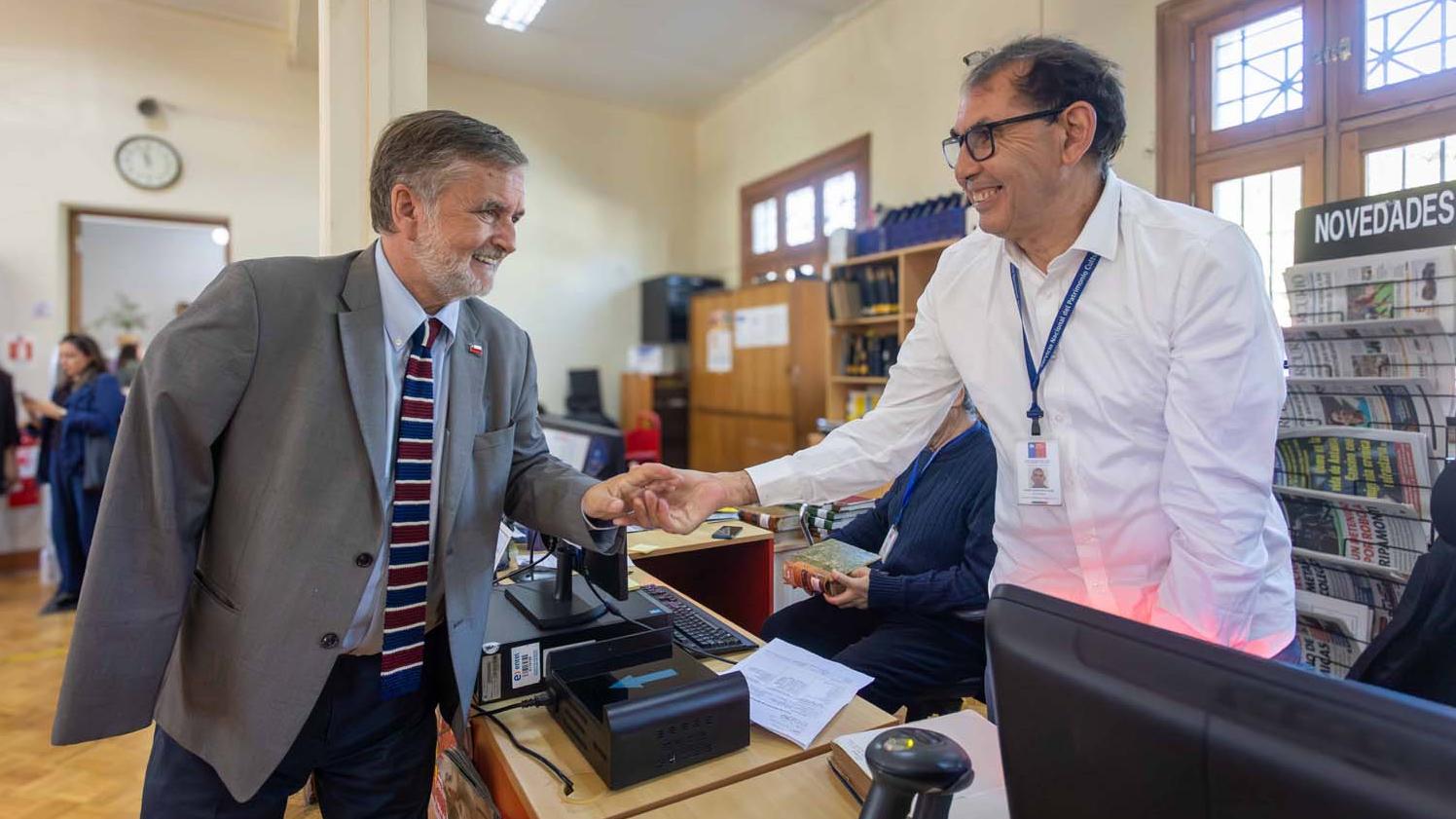 El ministro Francisco Undurraga junto a un funcionario de la Biblioteca Santiago Severin